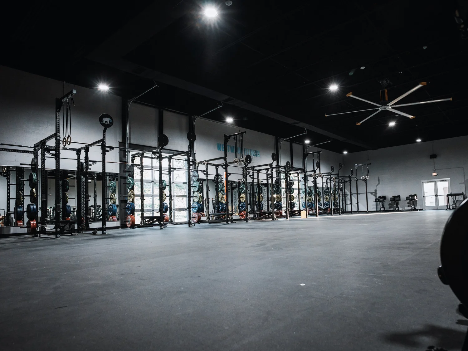 Power rack row with loaded barbells at Westwood Fitness