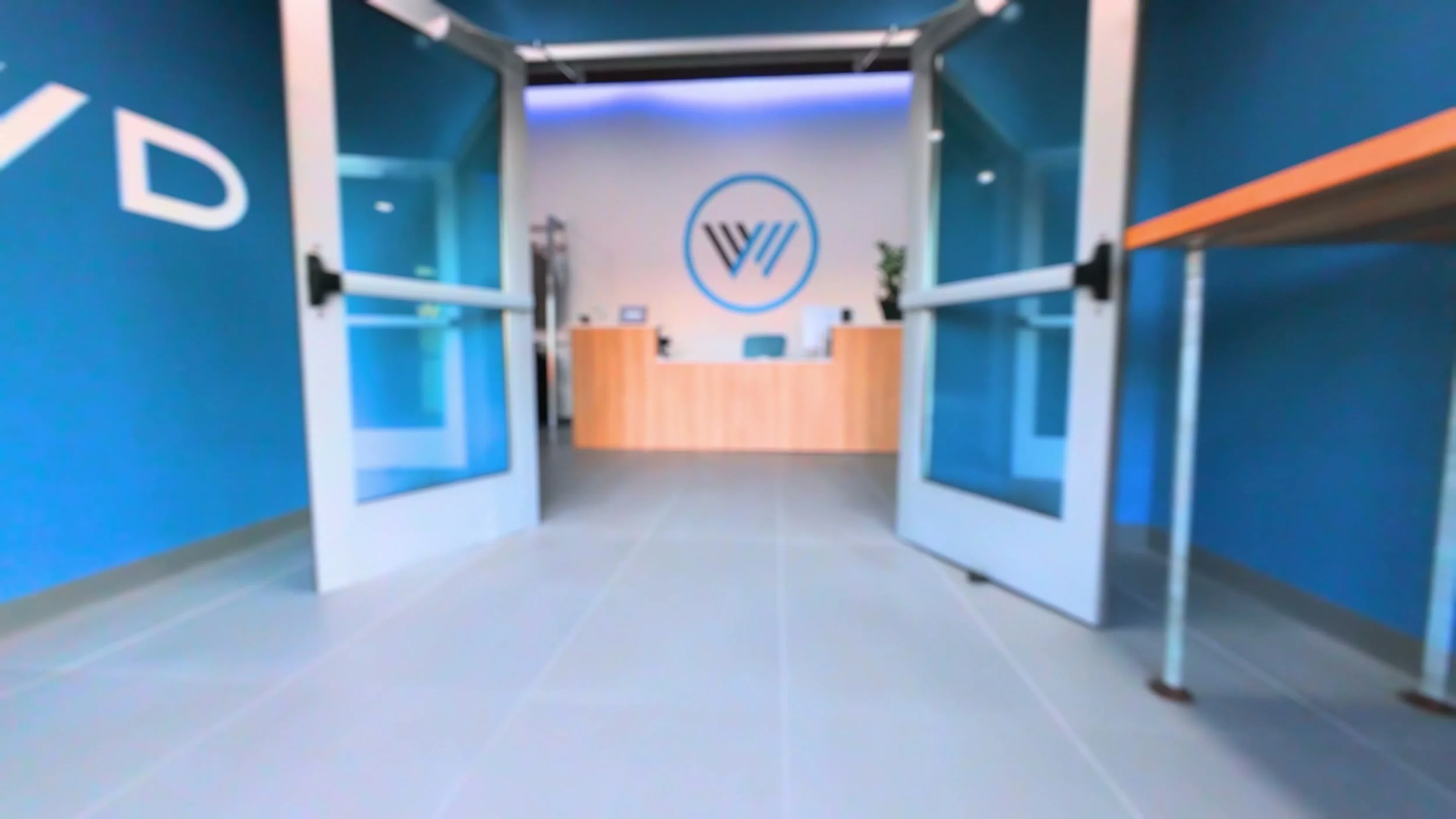 The Westwood front desk under the backlit W logo, seen from the front doors