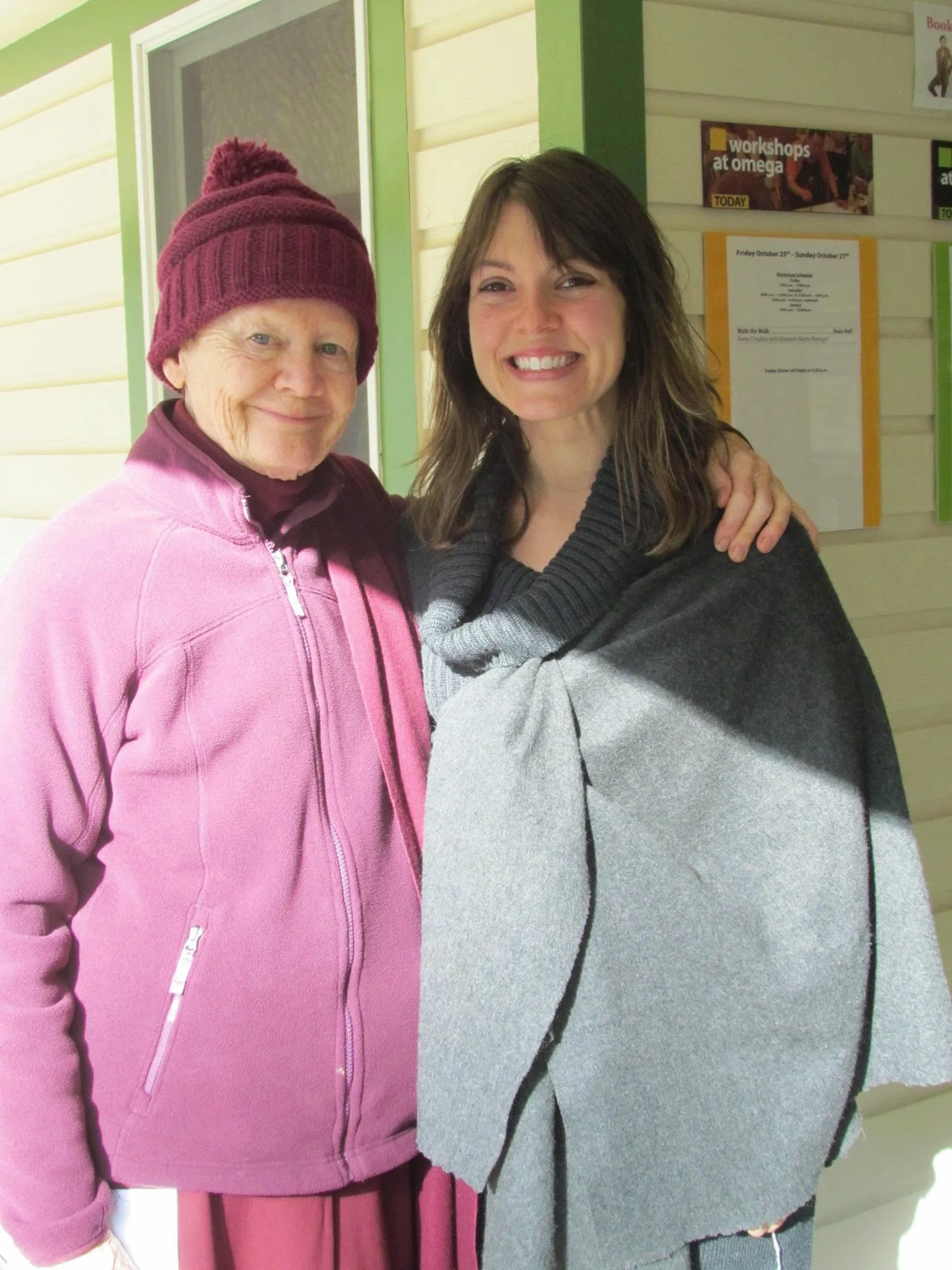 Gifting a wool cap to Pema Chodron at Omega bookstore. Each stitch knitted with Buddhist mantra