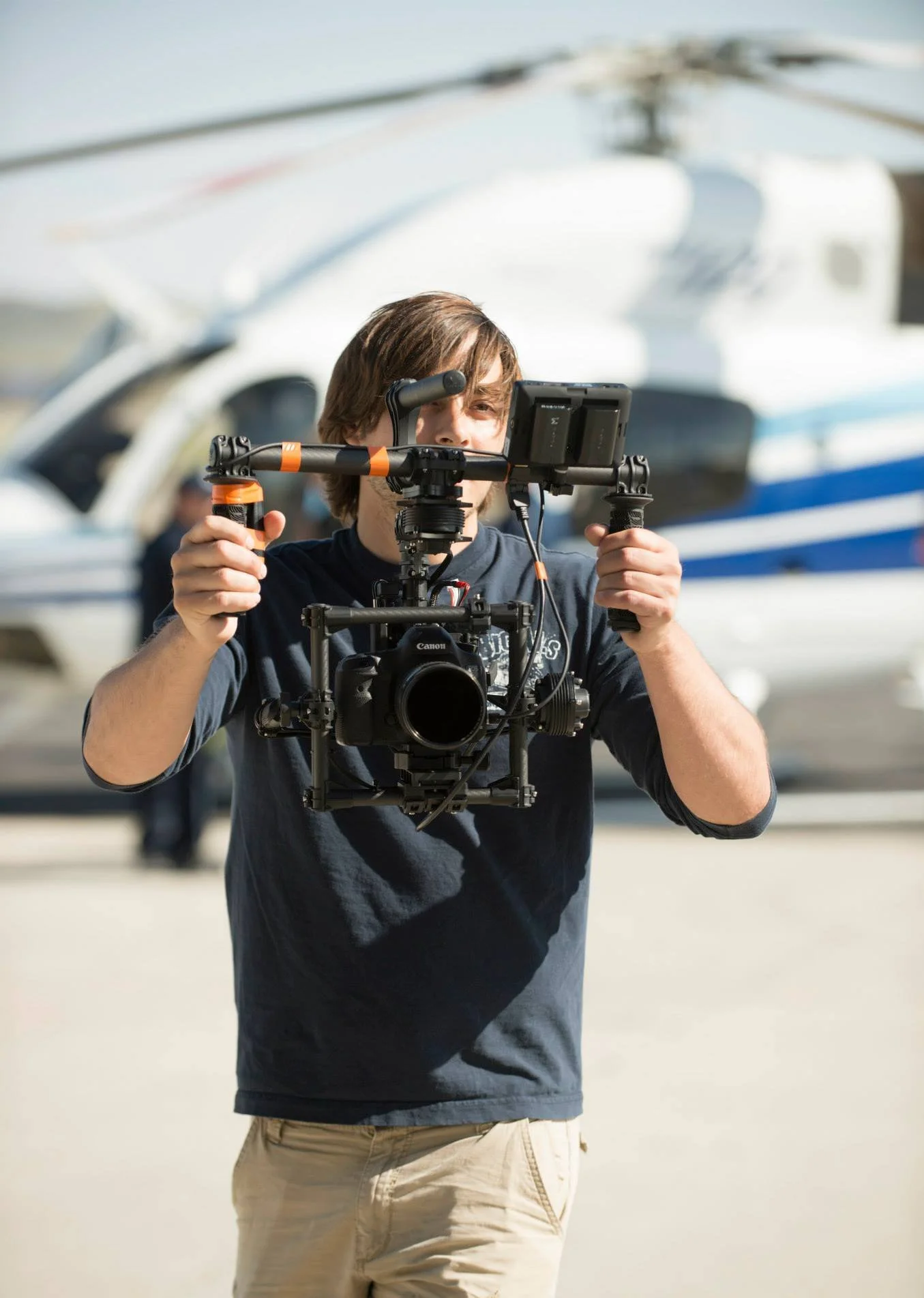 Jon Conti operating a camera on a gimbal while filming on location in Idaho.