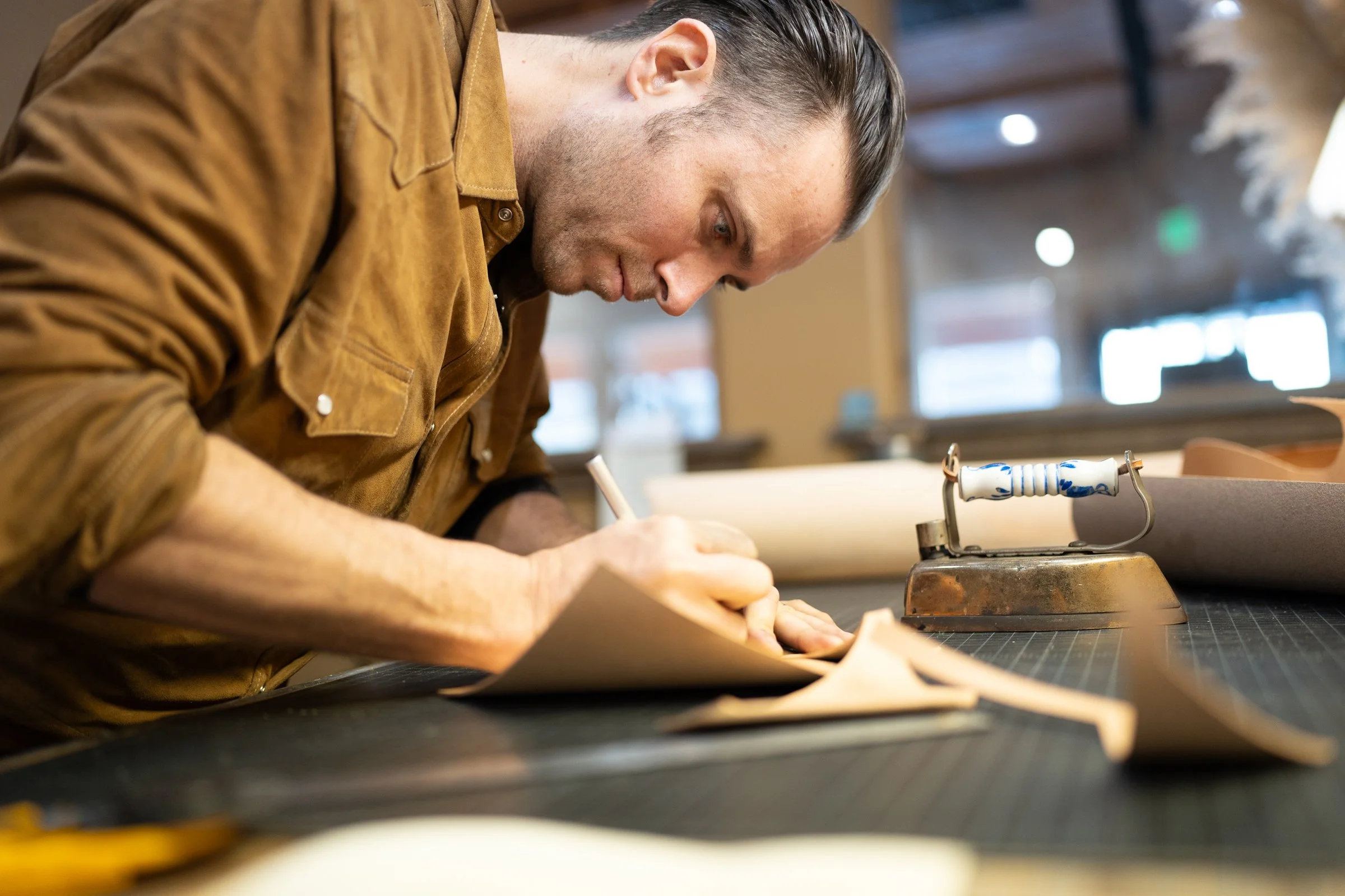 Bootmaker handcrafting leather boots in a workshop in McCall, Idaho.