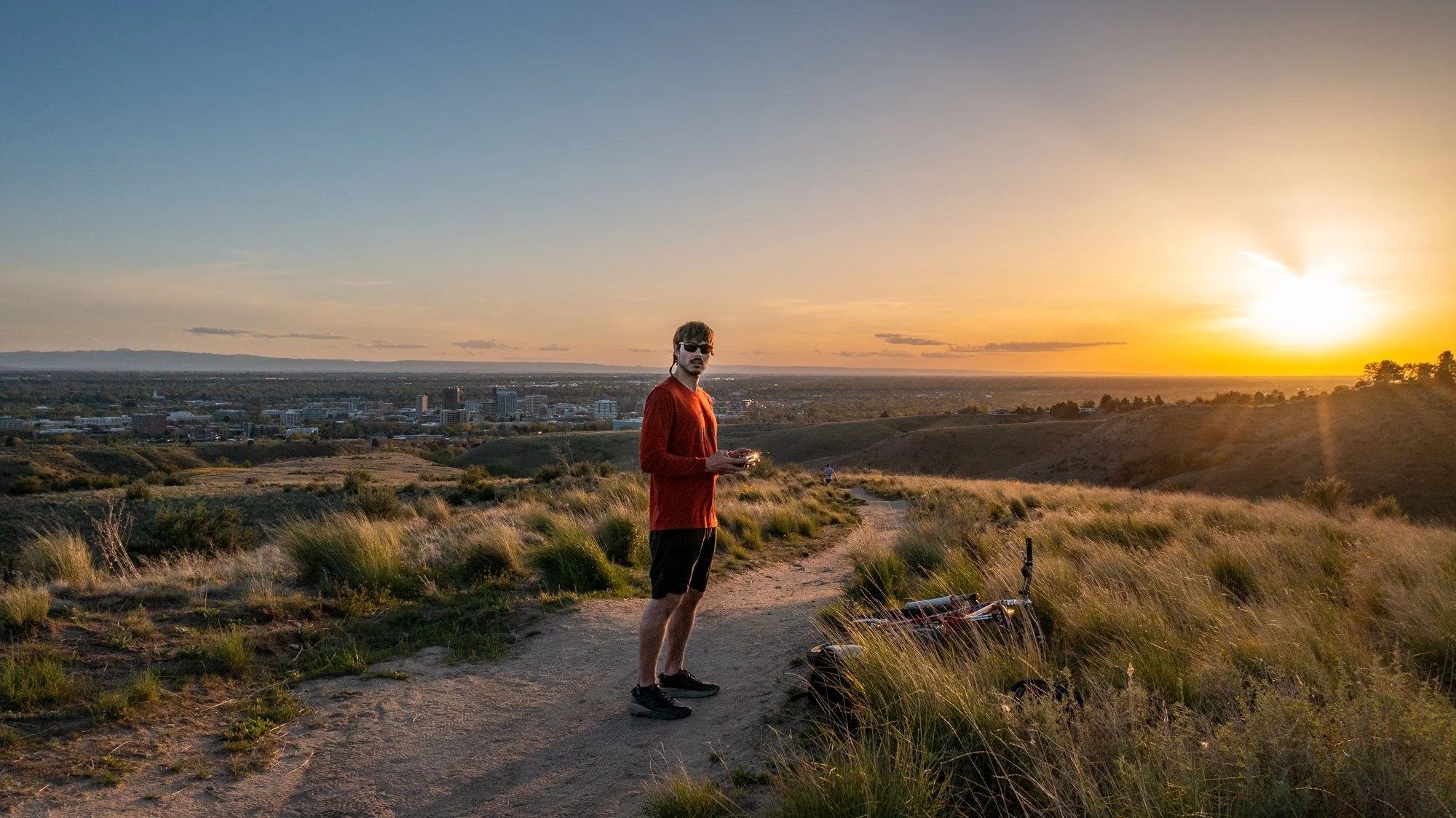 Jon Conti operating a drone over Boise, Idaho at twilight, capturing aerial footage of the city skyline.