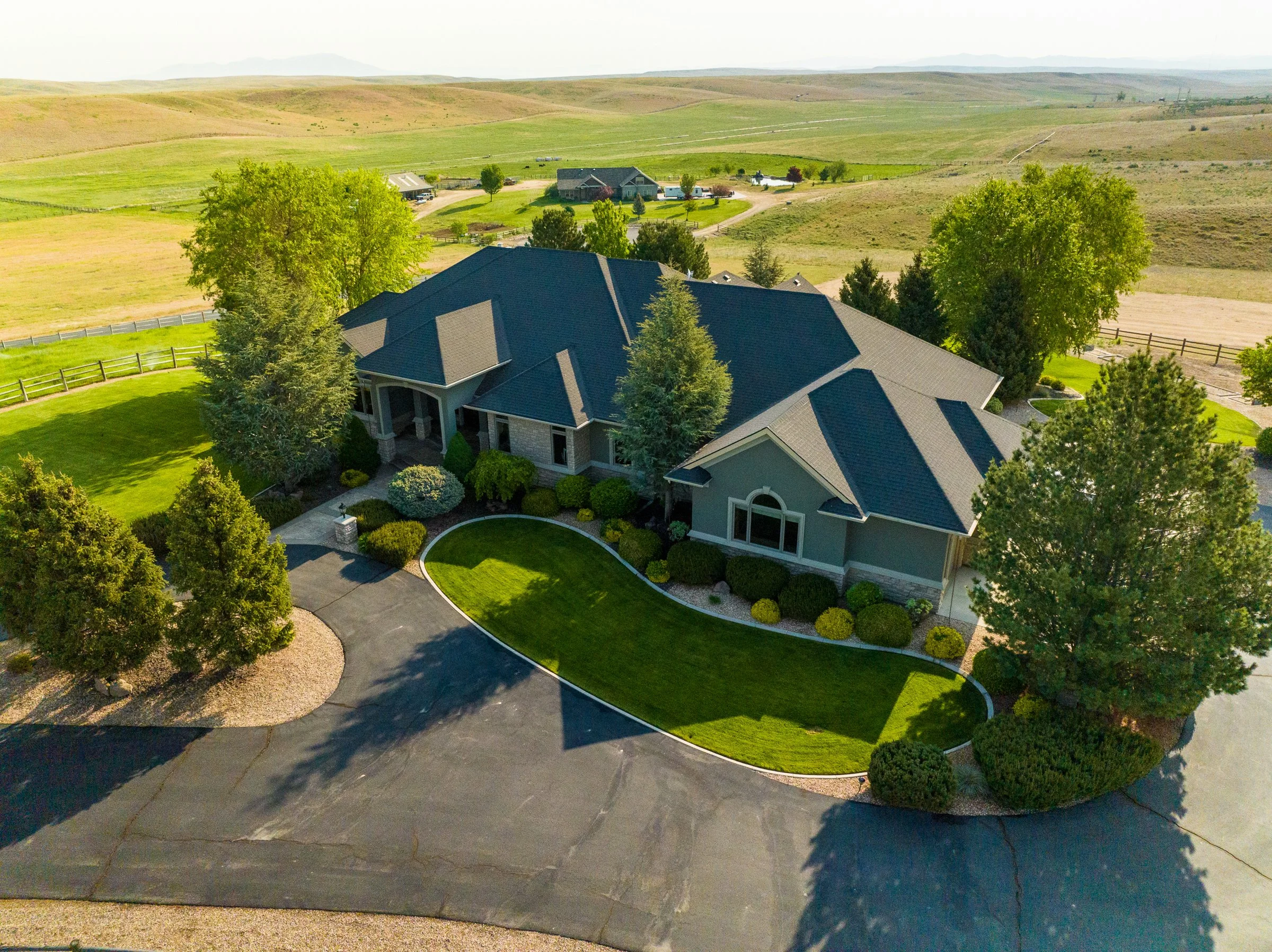 Aerial drone photo of a luxury home in the Boise foothills, captured by Jon Conti Visuals for high-end real estate marketing.