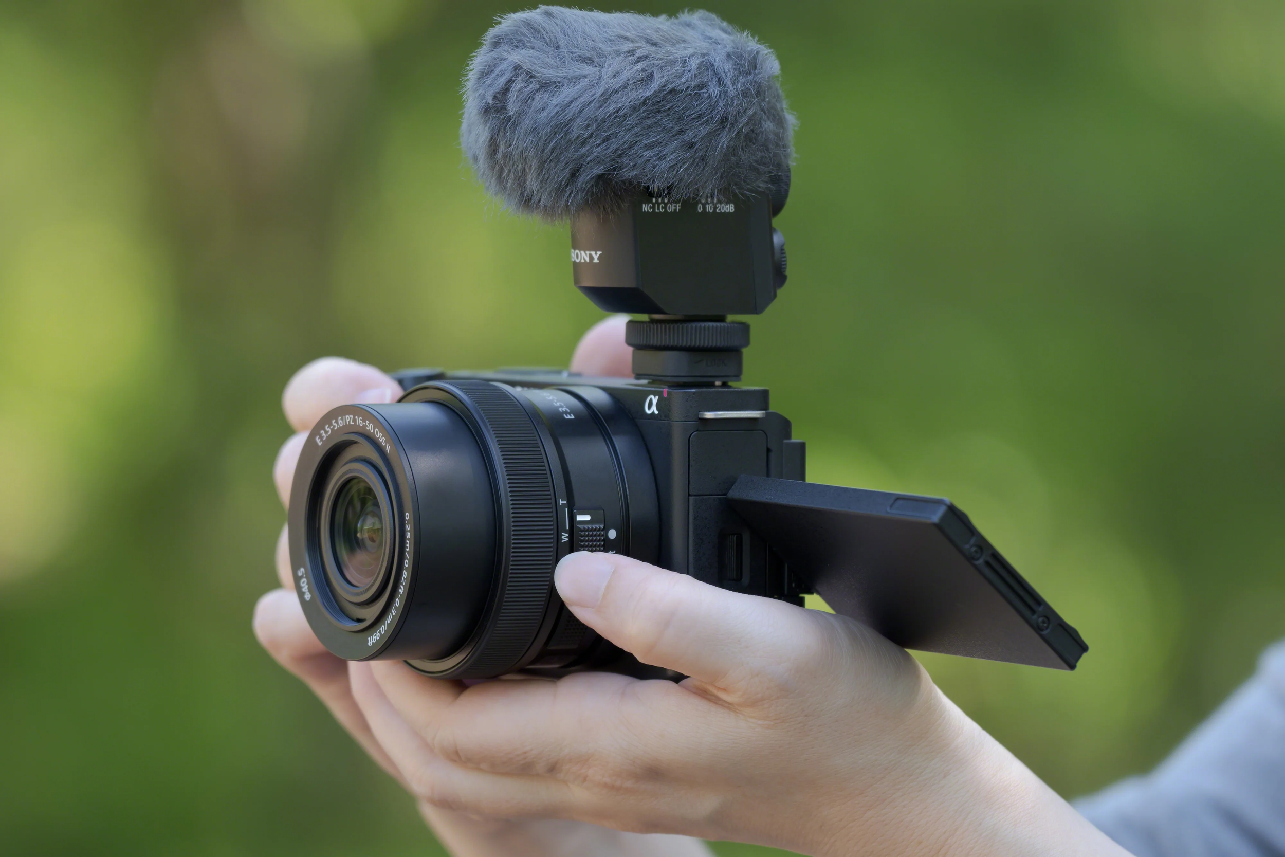 Sony ZV-E10 mirrorless camera with flip-out screen and external microphone used for vlogging