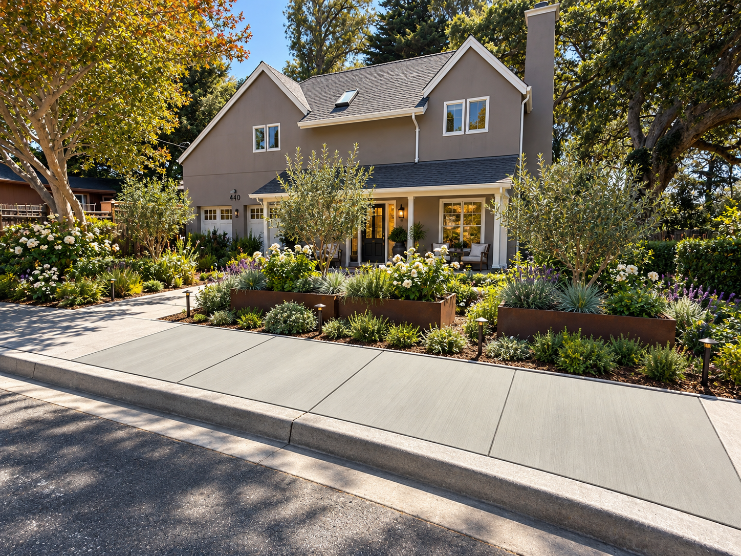 Finished concrete sidewalk along a landscaped residential frontage.
