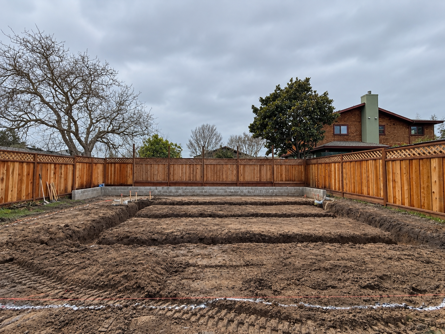 Foundation footing trenches excavated for a backyard ADU.
