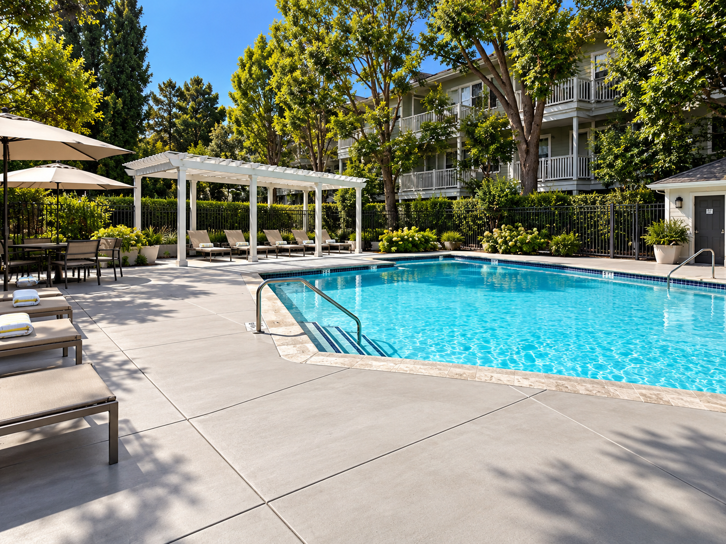Broom-finished concrete pool deck with control joints and drainage detailing.
