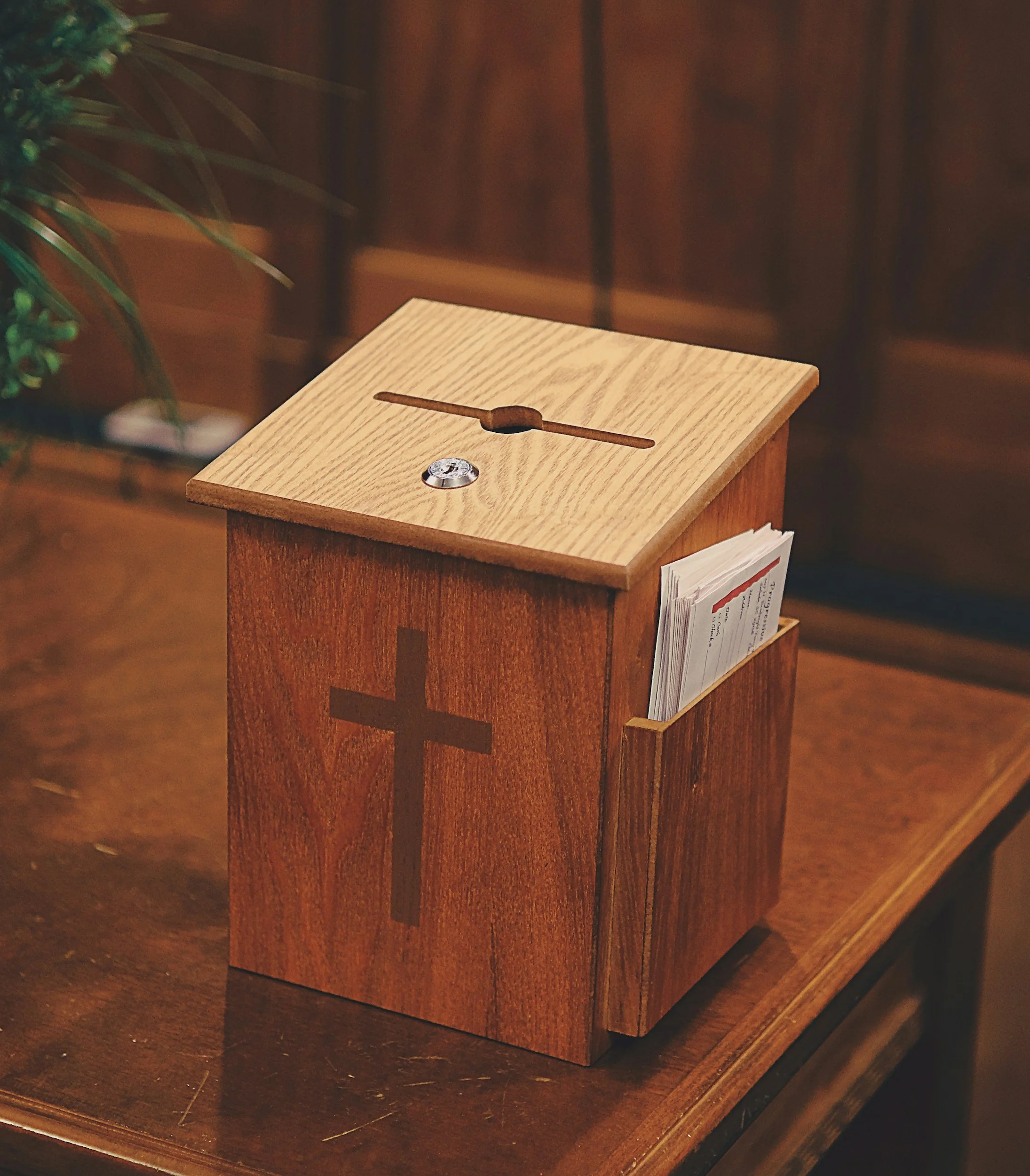 Picture of a donation box with a cross on the frontn used for tithing at Bay Haven.