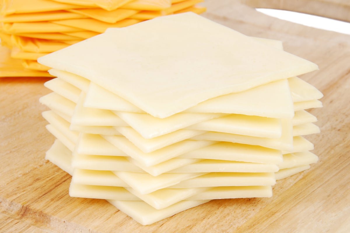 A-Stack-of-White-American-Cheese-Slices-in-Front-of-a-Stack-of-Yellow-American-Cheese-Slices.jpg