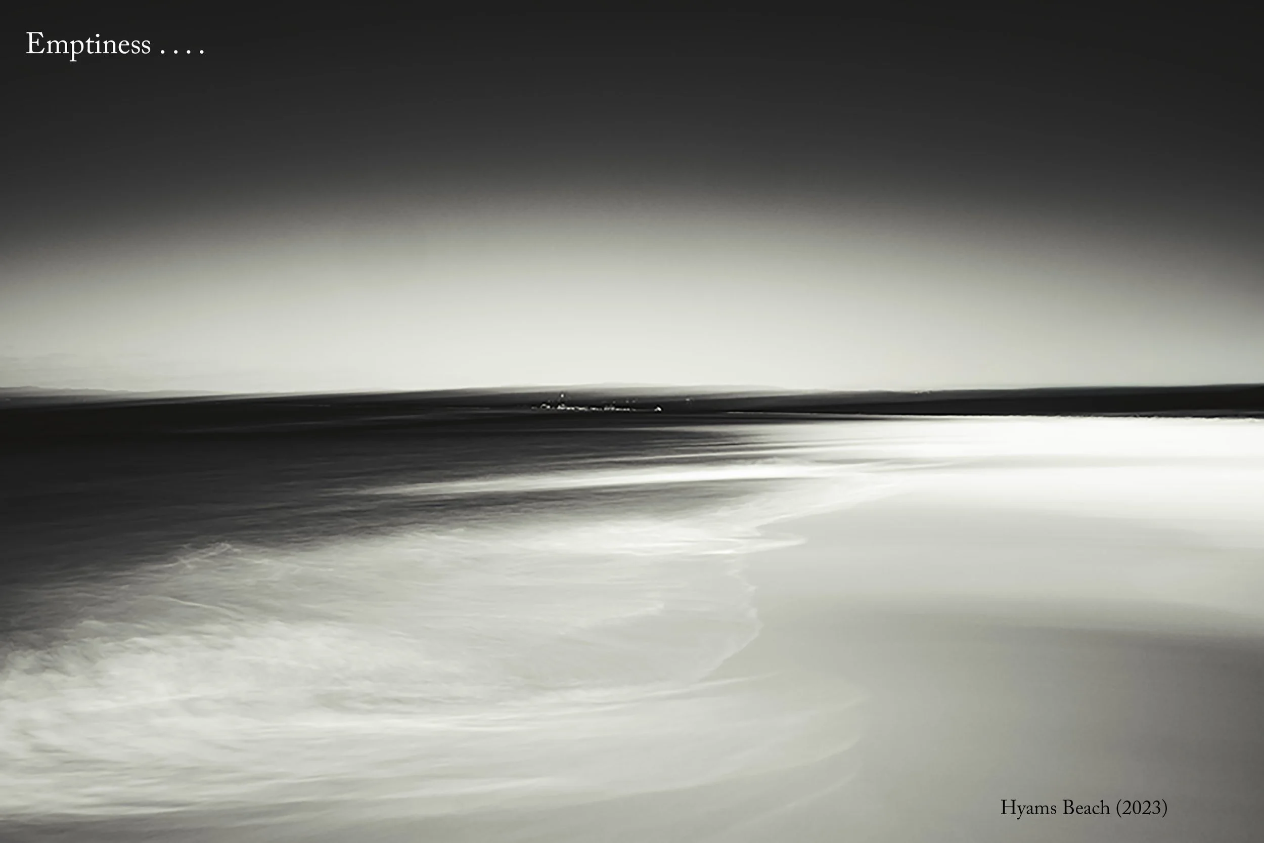 An image of an empty beach captured via intentional camera movement. The title is Hymans Beach (2023). The caption says Emptiness . . . .