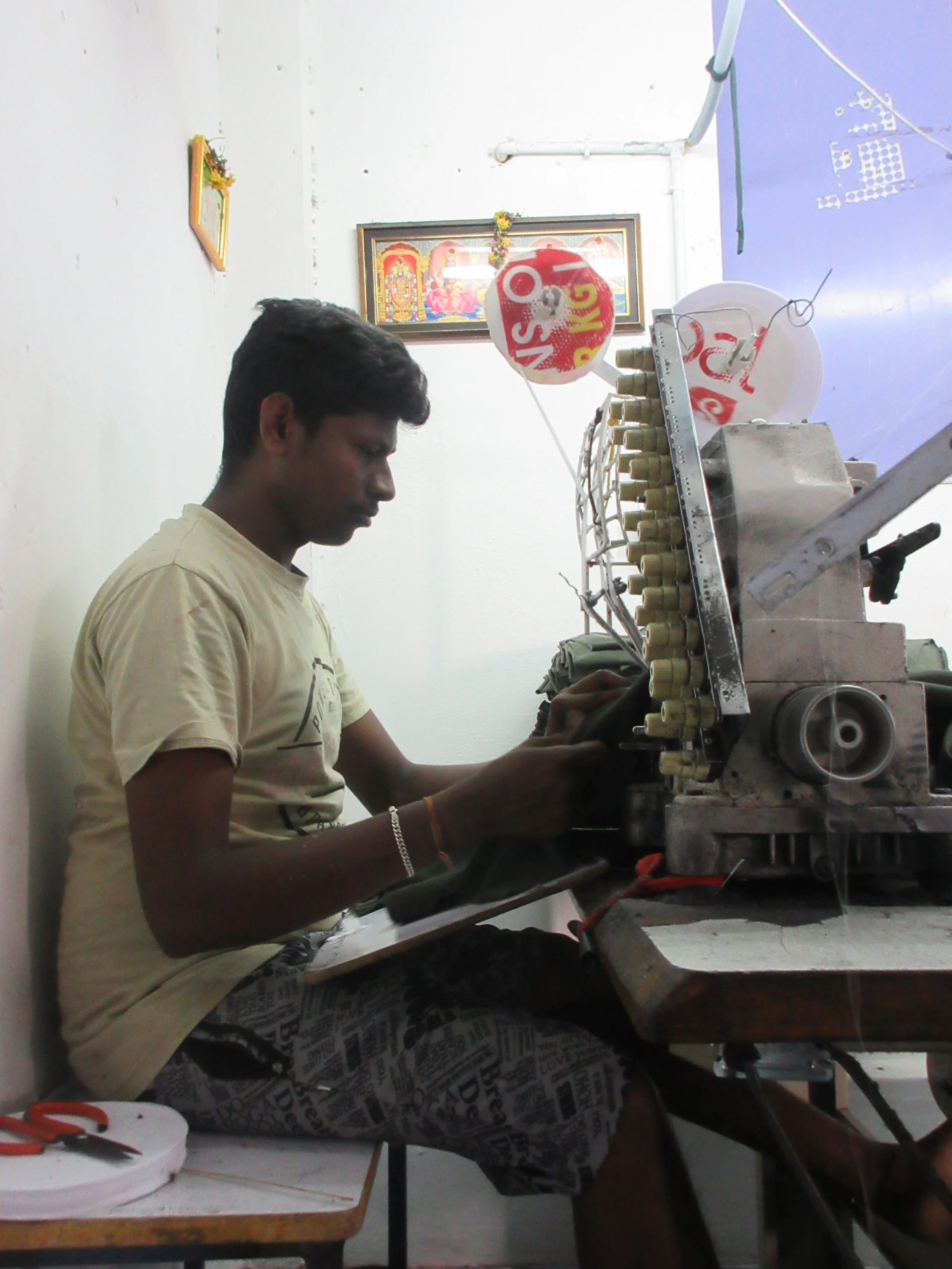 “So this a machine which creates designs in the fabric. There are several threads which go into the same needle – 7 threads into 4 needles – to make piping and other trimmings. This is only in the house – they have two machines. If the machine breaks