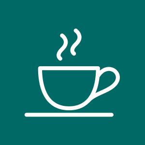 A steaming hot cup of coffee or tea on a saucer.