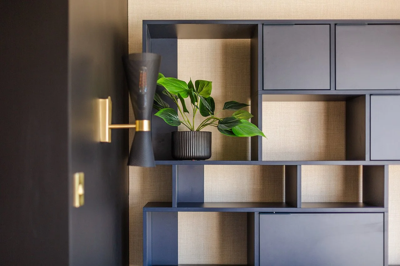 Modern home office in Gamlingay with custom Tylko open storage, dark blue shelving and warm contemporary lighting, designed to maximise space in a compact area.