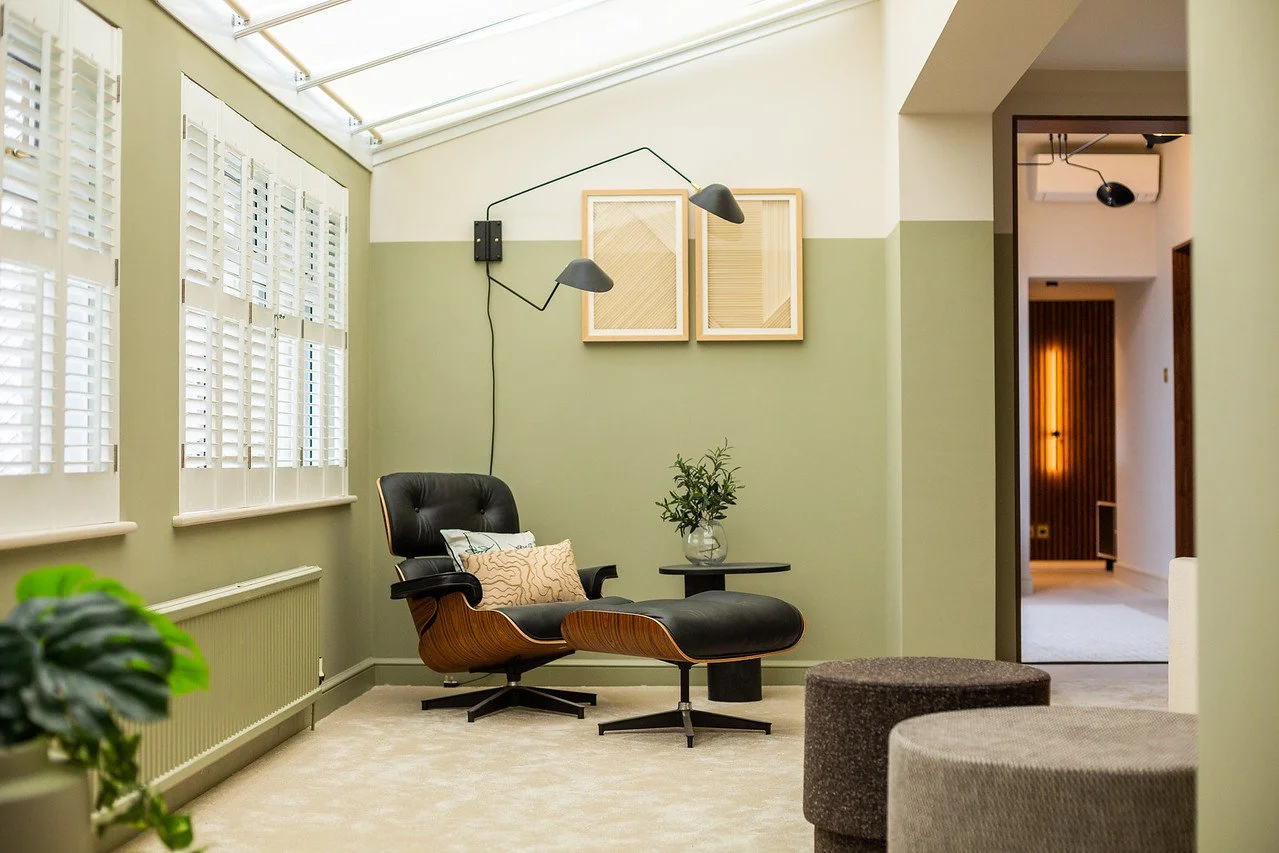 Eames lounge chair and sculptural lighting in Gamlingay living room renovation near Cambridge