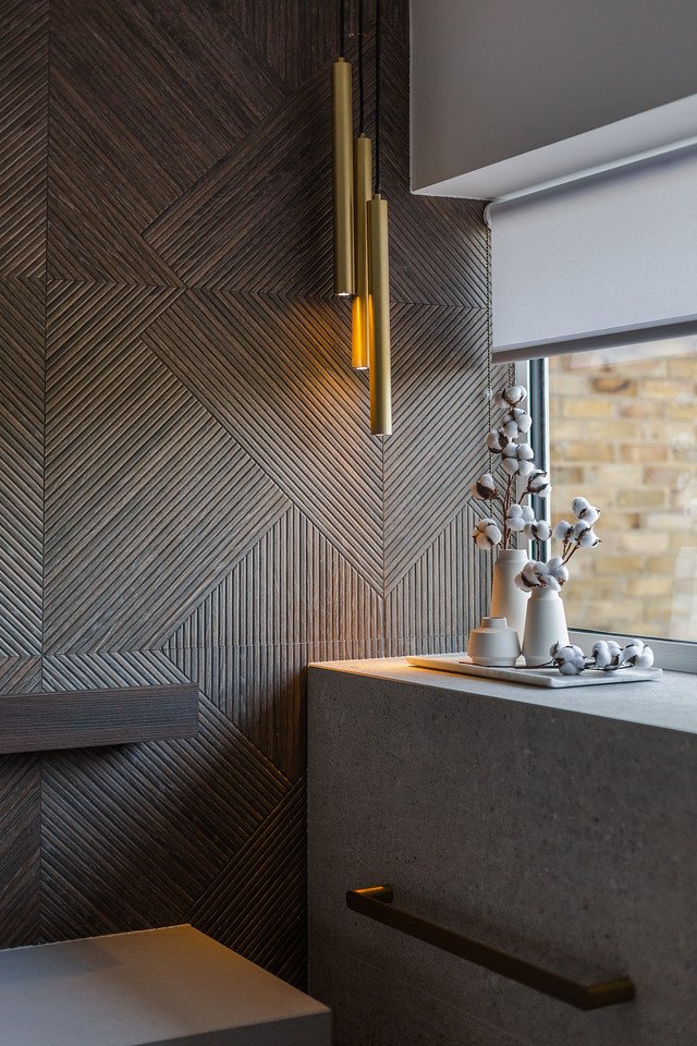 Textured wall with brass pendant lights and cotton stems in Gamlingay renovation near Cambridge