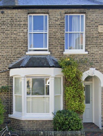 Exterior of Mawson Road Cambridge home showing traditional brick facade and bay window