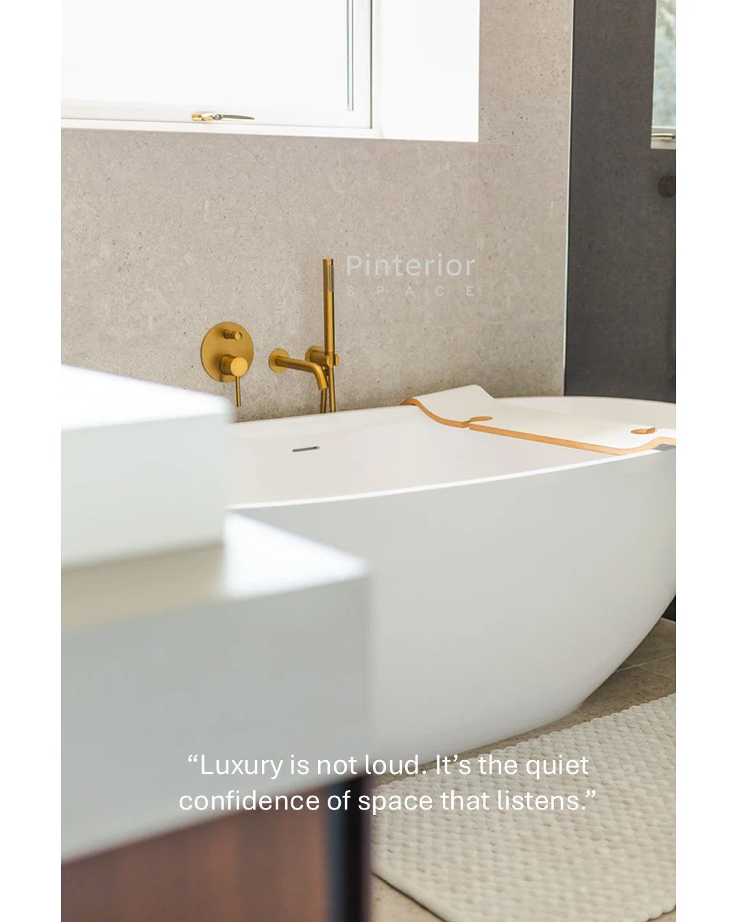 Modern organic bathroom with freestanding bath, brass fittings, and warm contemporary styling by Pinterior.