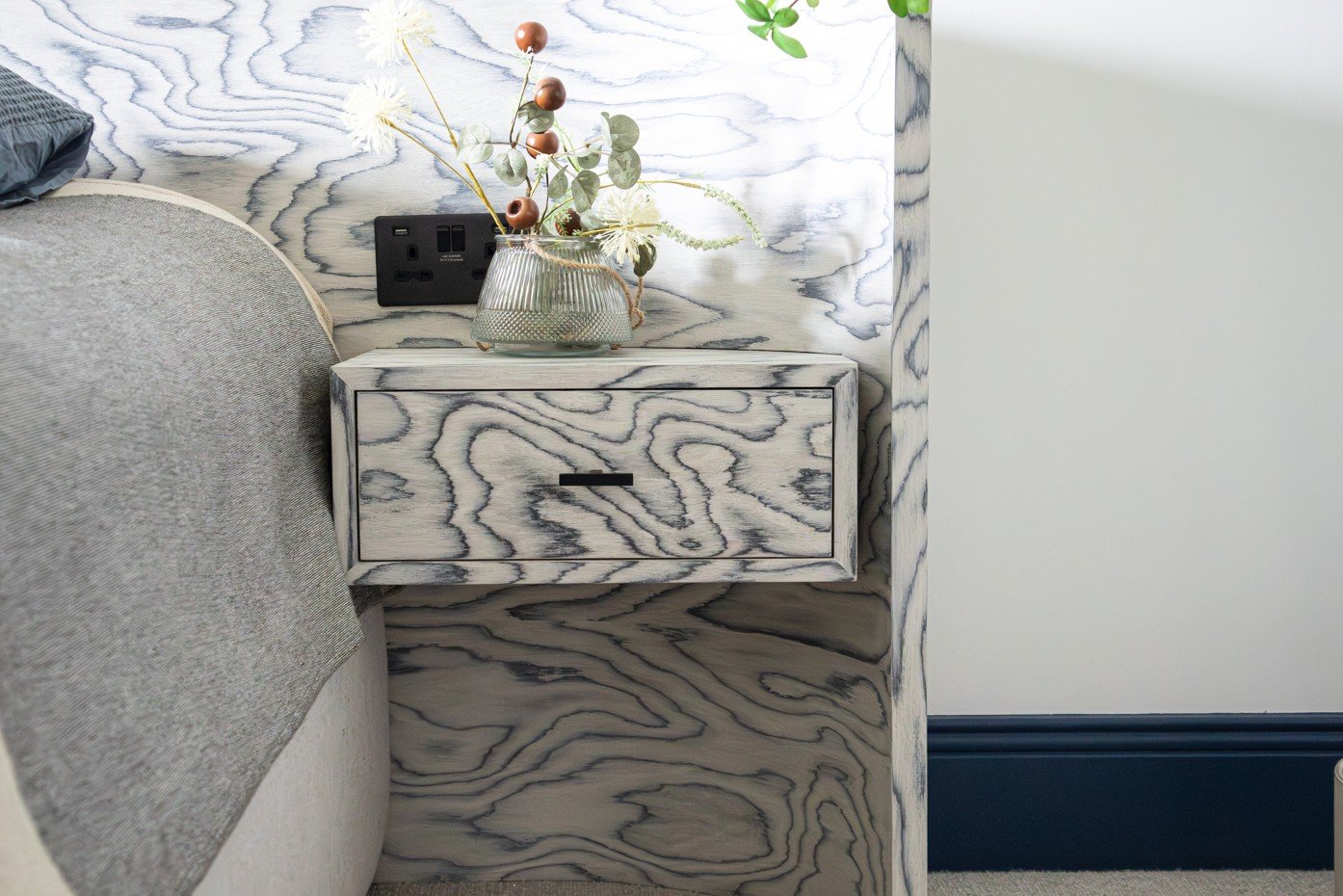 Contemporary detail of a bespoke curved headboard in Sattasats wood veneer, designed for the Water Lane project in Cambridge.