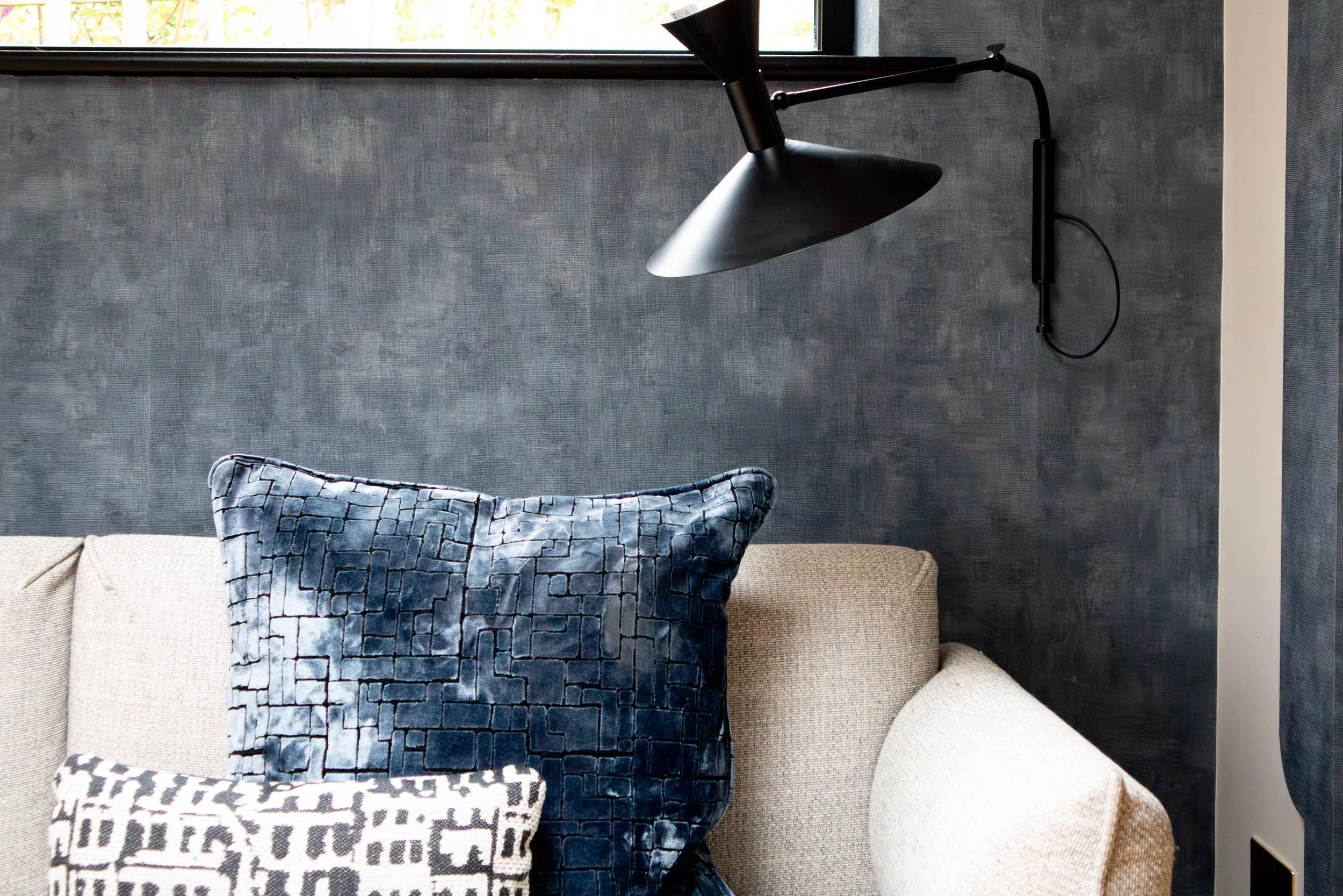 De Marseille metal by Le Corbusier  wall light used as task lighting above a sofa in a Shelford Cambridge interior project.