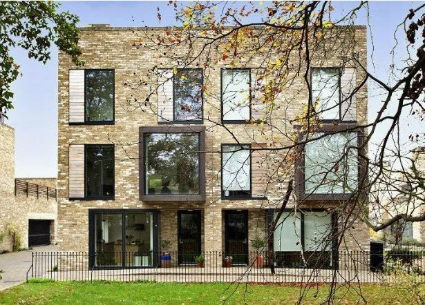 Modern residential building in Henslow Mews, Cambridge CB2 — brick facade, large windows, and garden, setting the scene for a kitchen renovation project.