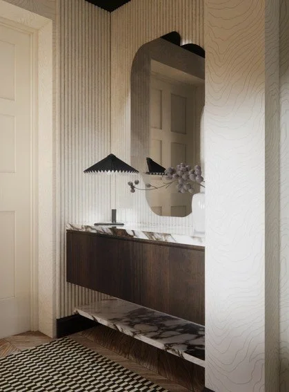 “Bespoke vanity unit and sculptural mirror in a Welwyn Garden City interior, featuring natural materials, layered textures and quiet luxury — designed to reflect calm and individuality.