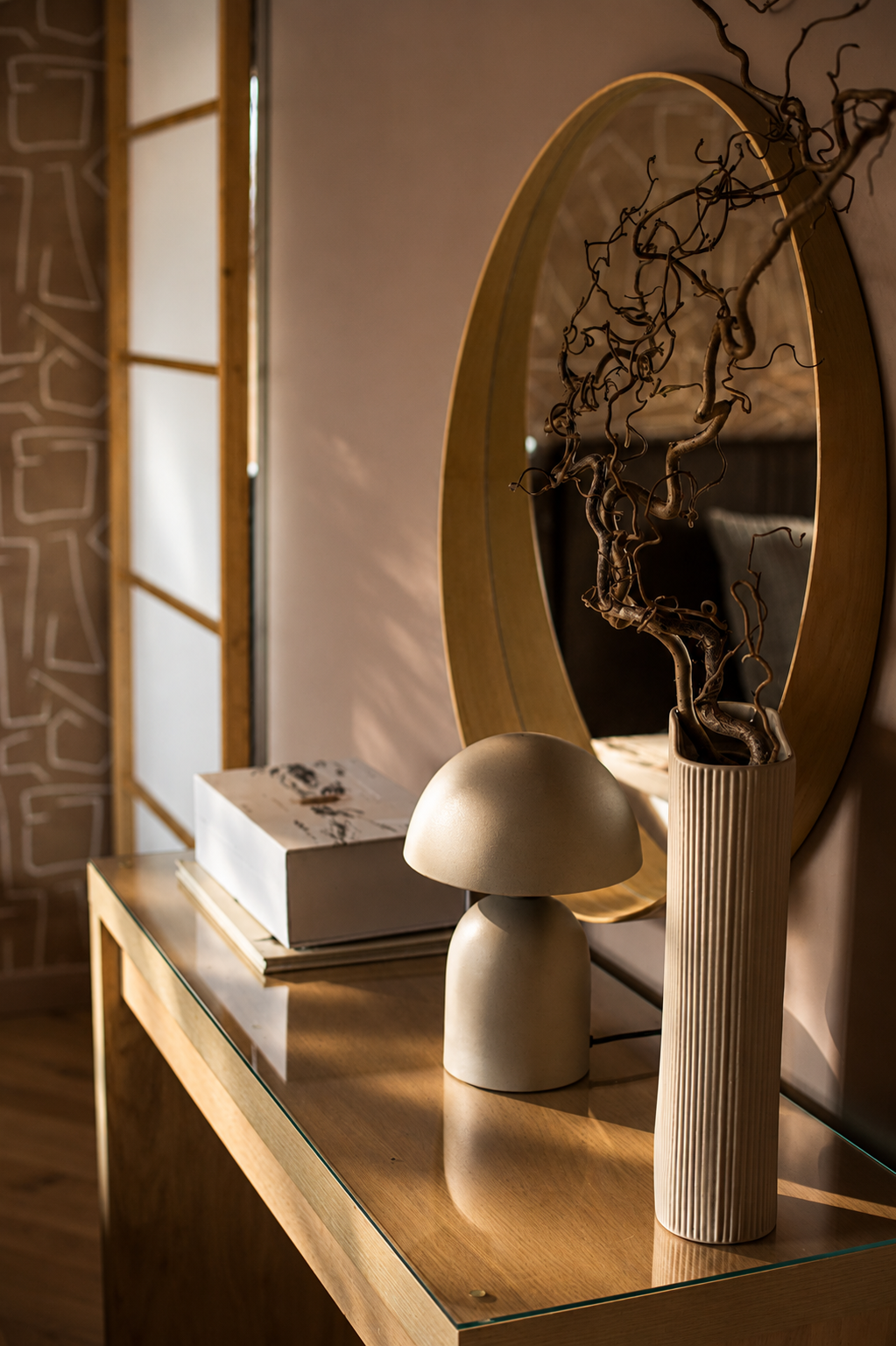 A carefully styled vignette within a residential project in Great Shelford, Cambridge. Warm timber finishes, sculptural accessories and layered textures create a sense of depth and personality, while natural light highlights the richness of the mater