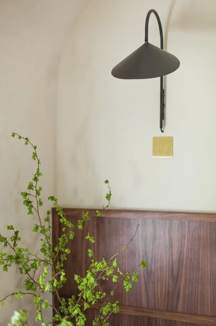 Minimalist wall light and wood panel detail in a Japandi-inspired South Cambridgeshire interior