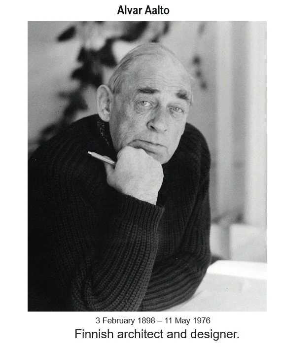 Black-and-white portrait of Alvar Aalto seated with a pencil, wearing a ribbed sweater, in a softly lit setting.