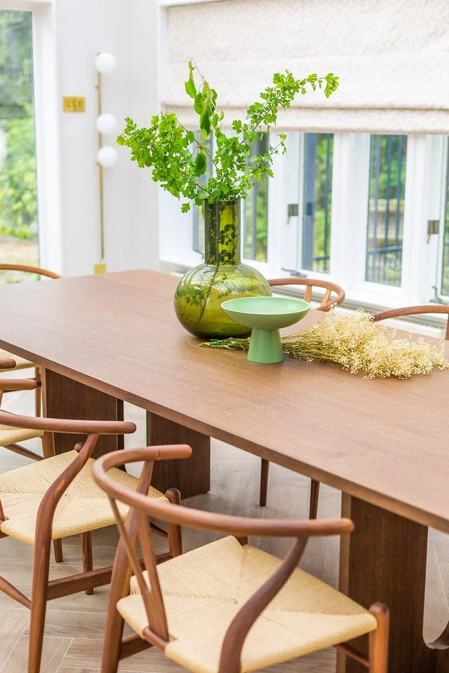 Gamlingay dining room with natural textures, soft light, and garden-facing windows.