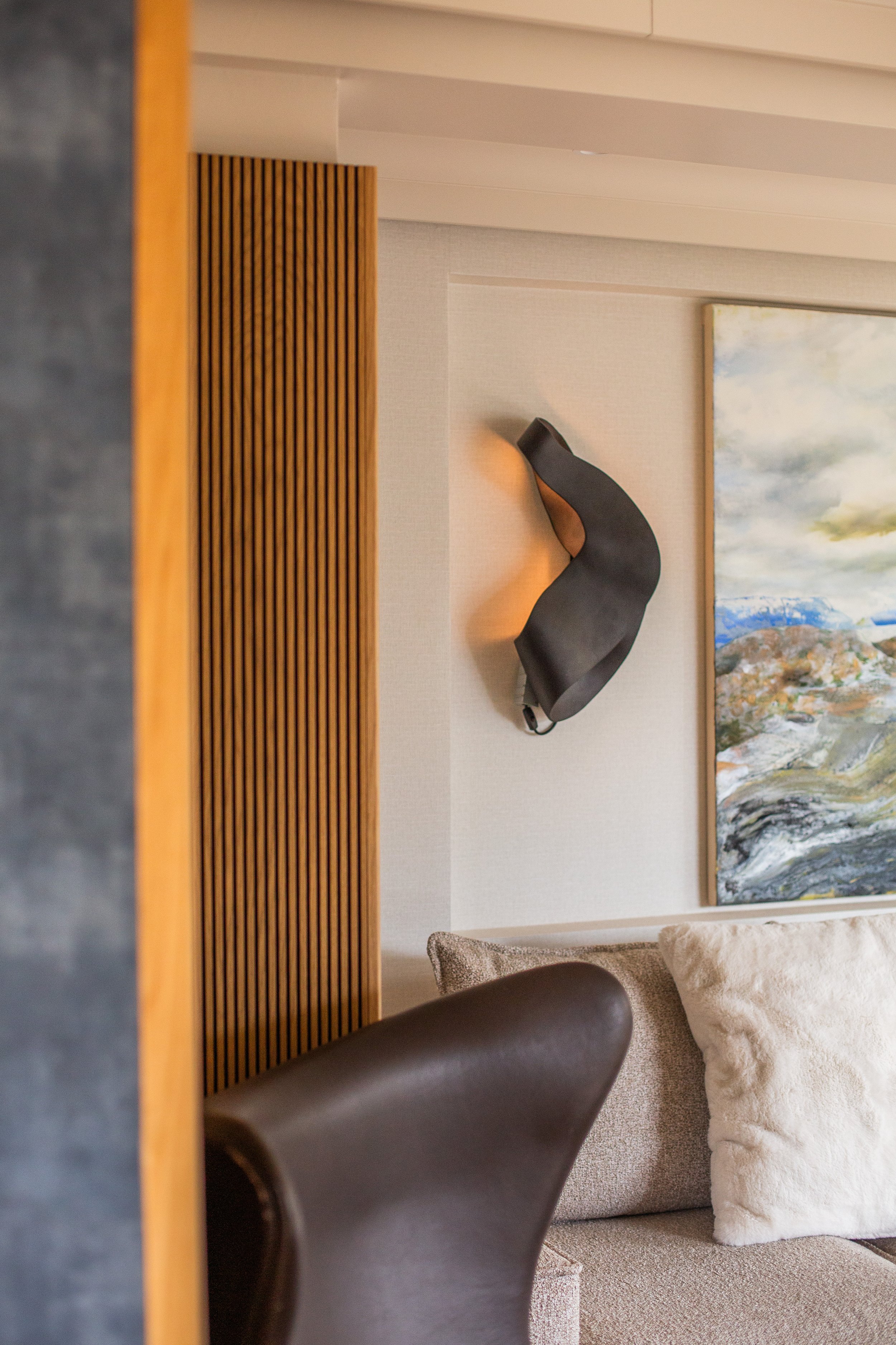Warm sculptural wall light by Ferm Living in a Shelford Cambridge living room, creating ambient mood lighting
