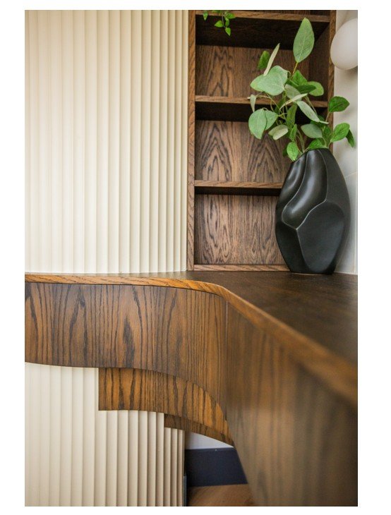 Curved timber desk with fluted wall detail from bespoke Shelford interior design project