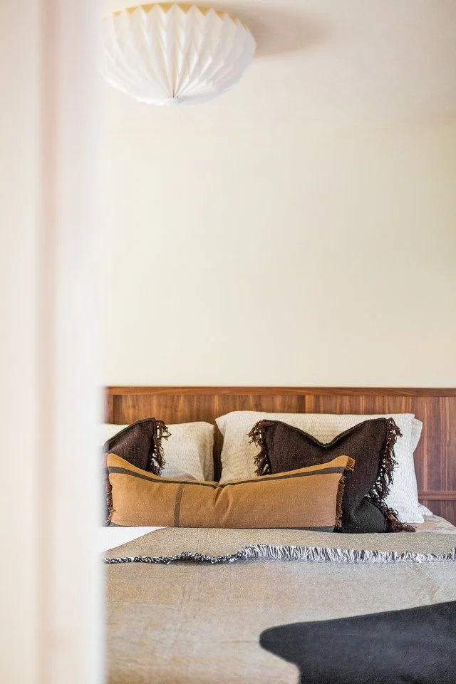 Bespoke bedroom in a Grade II listed South Cambridgeshire home with layered textures and sculptural lighting