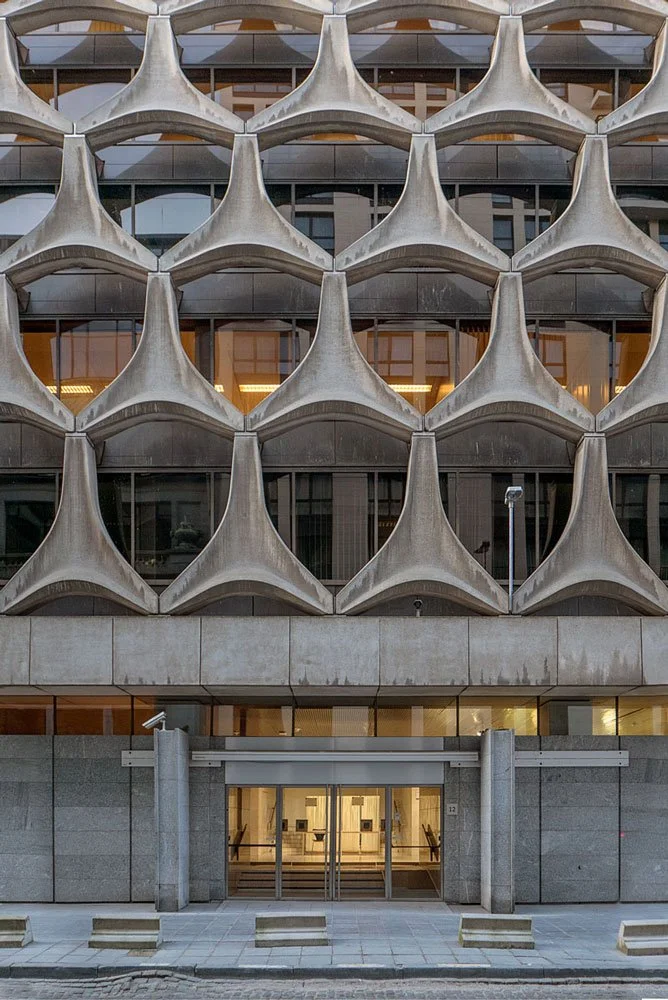Brutalist facade of BNP Paribas building in Paris designed by Marcel Breuer, with sculptural concrete modules and deep-set windows.