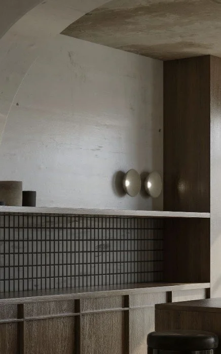 “Japandi kitchen design inspiration with natural timber, curved ceiling, minimalist lighting and textured tile backsplash.”