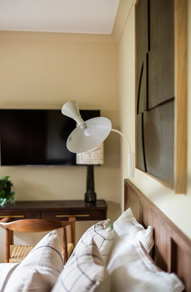 Guest bedroom corner with mid-century desk and sculptural lighting in Gamlingay renovation near Cambridge