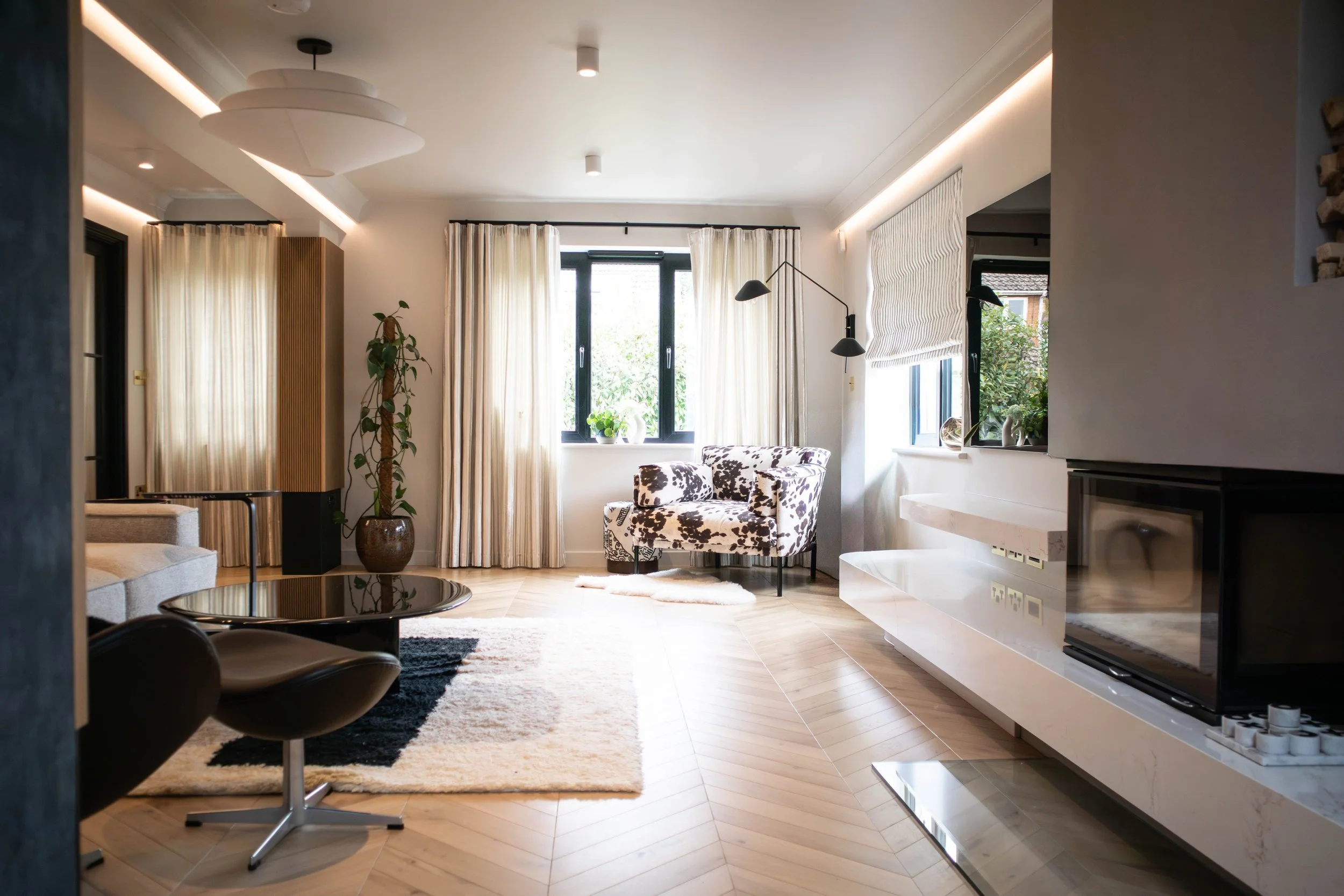 Bespoke living room design featuring an integrated wood burner, recessed log store, and balanced architectural composition tailored to the room’s proportions