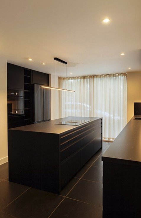 Cambridge kitchen renovation with minimalist black cabinetry, soft natural light, and poetic spatial clarity