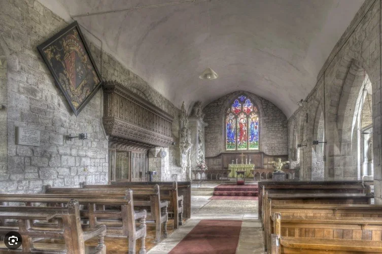 nterior of St Margaret’s Church in Abbotsley, Cambridgeshire, with stained glass, pews, and altar.