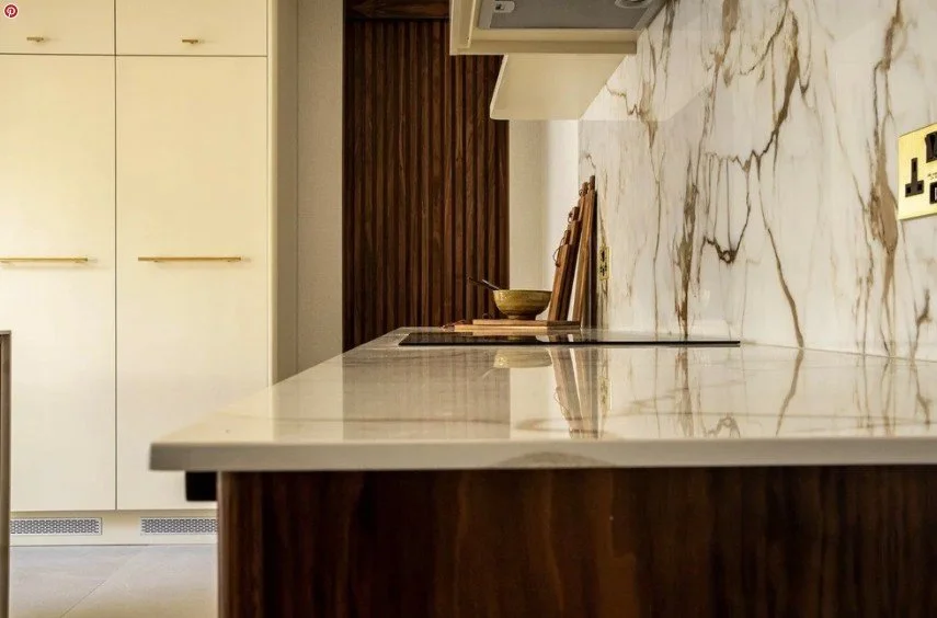 Contemporary kitchen with marble backsplash and wood-panelled wall
