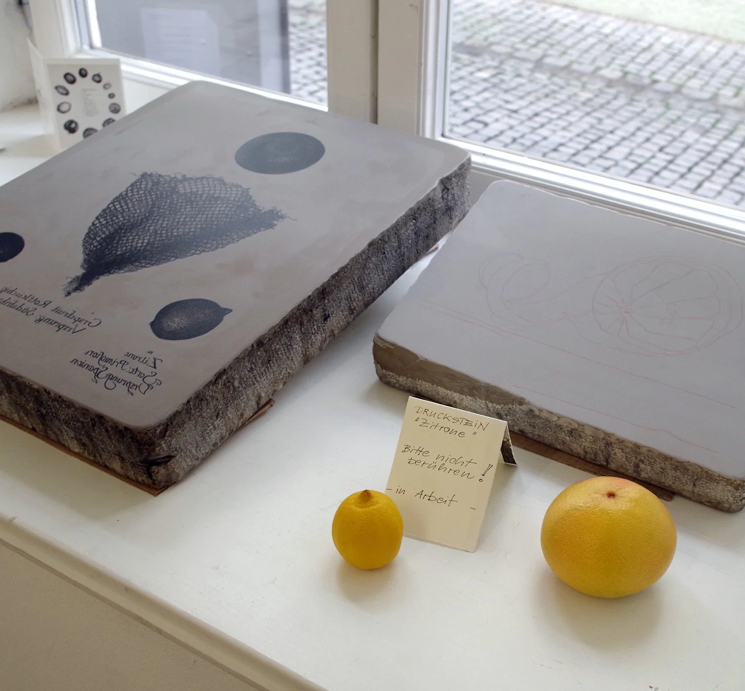  Lithography stone that had been used for printing alongside another stone with initial sketch in red chalk. The second stone was fully drawn and printed during the course of the exhibition. 