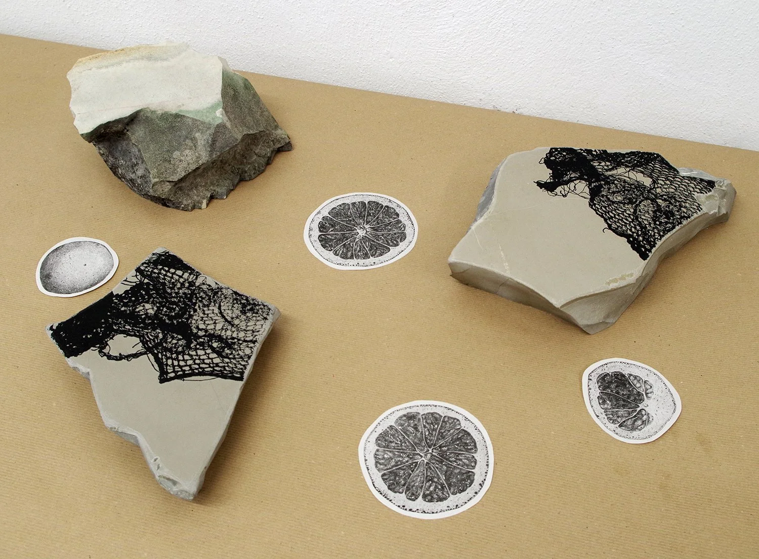  Lithographic stone objects and incidental stone lithography prints on newsprint. The lithographic stones were collected in a local (abandoned) quarry in Solnhofen where fine lithographic stones were historically quarried. 