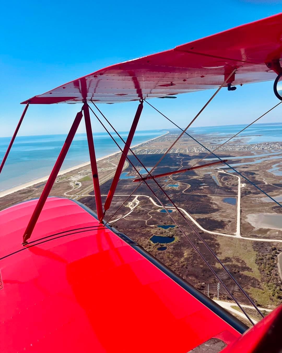 Coastal flying over Galveston Island State Park, where a successful controlled burn rejuvenates the landscape beneath clear blue skies. 🏝️ 

#Wacobiplane #galveston #lovegalveston #galvestonbay #thingstodoingalveston #thingstodintexas #radialengine 