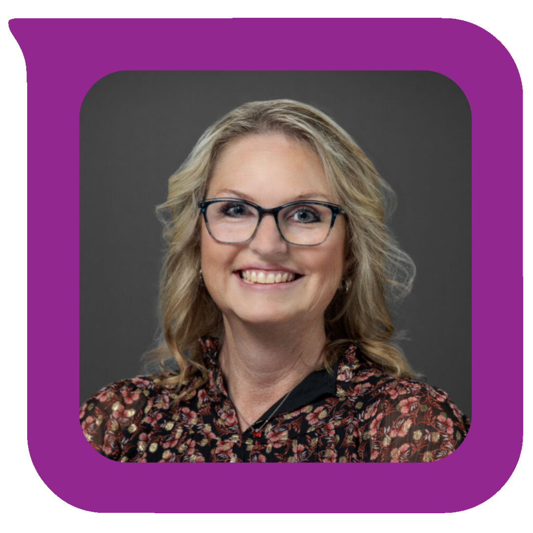 Photograph of a woman with blonde hair, glasses, and a floral blouse smiling at the camera.