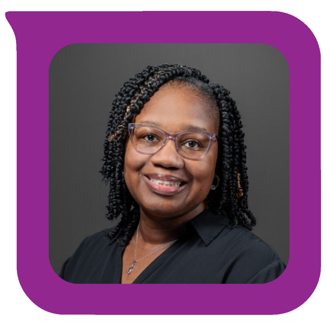 Portrait of an African American woman with glasses, curly hair, and a black blouse, smiling against a gray background.