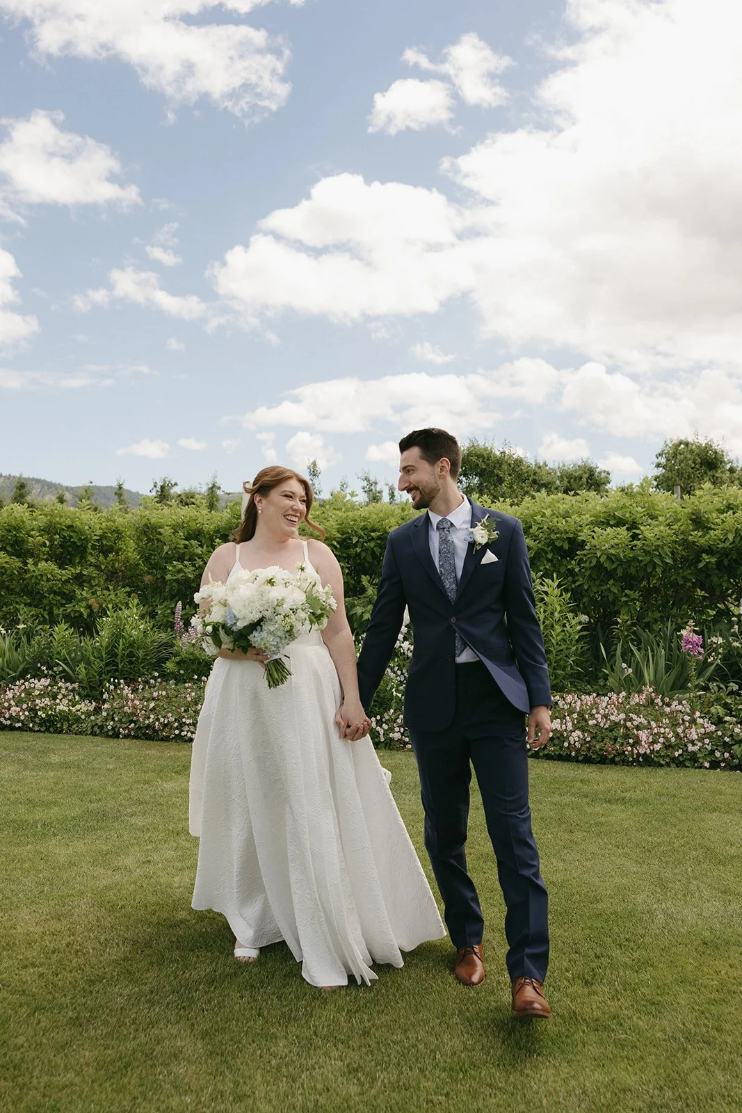 the-orchard-hood-river-bride-groom-walking-orchard-garden.jpg
