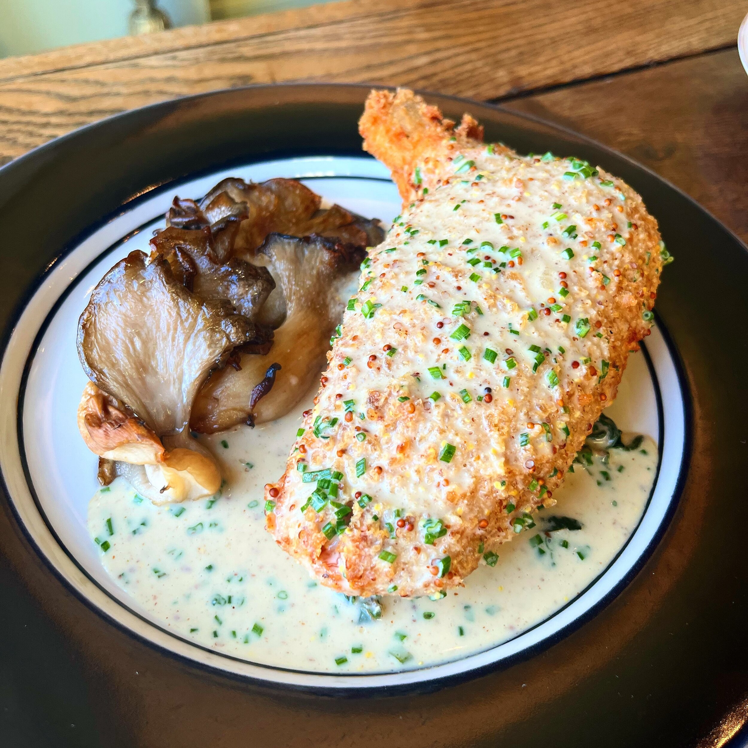If you haven&rsquo;t had our signature Chicken Cordon Bleu, what are you waiting for? 

An absolute delight, these flavorful chicken breasts are stuffed with gruyere and smoked bacon and finished with a bright mustard sauce. Served with braised green