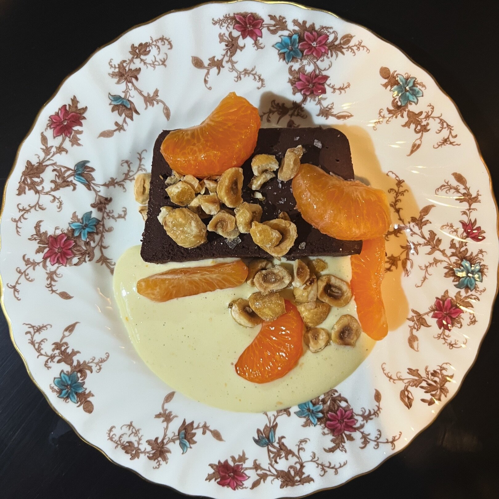 Chocolate + Orange 🤌 A beautiful marriage of flavors. Our new chocolate mousse terrine with mandarins, hazelnuts, and cr&egrave;me anglaise is a sumptuous way to end your evening at the Bistro. #justsayoui

#chocolatelover #dessert #chocolatedessert