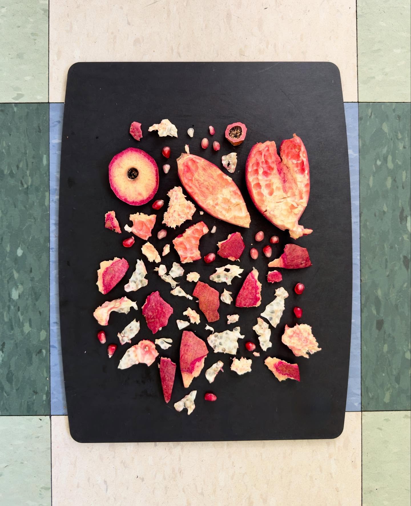 First of the season. #dogwalkdiarynyc #pomegranate #playwithyourfood #wastenot #foodscraps #peelappeal #checkedfloor #ephemeralartjourneysdaily