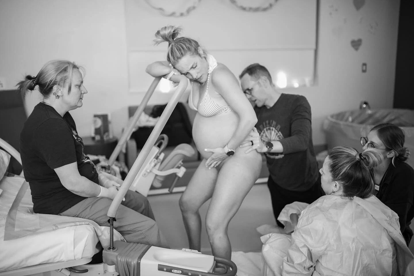 this is what an unmedicated hospital birth can look like : lights dimmed, room decorated (by the sweetest nurses @ ocotillo), she just got out of the tub, using the bar to push + also to rest in between, not hooked up to anything, while the birth tea