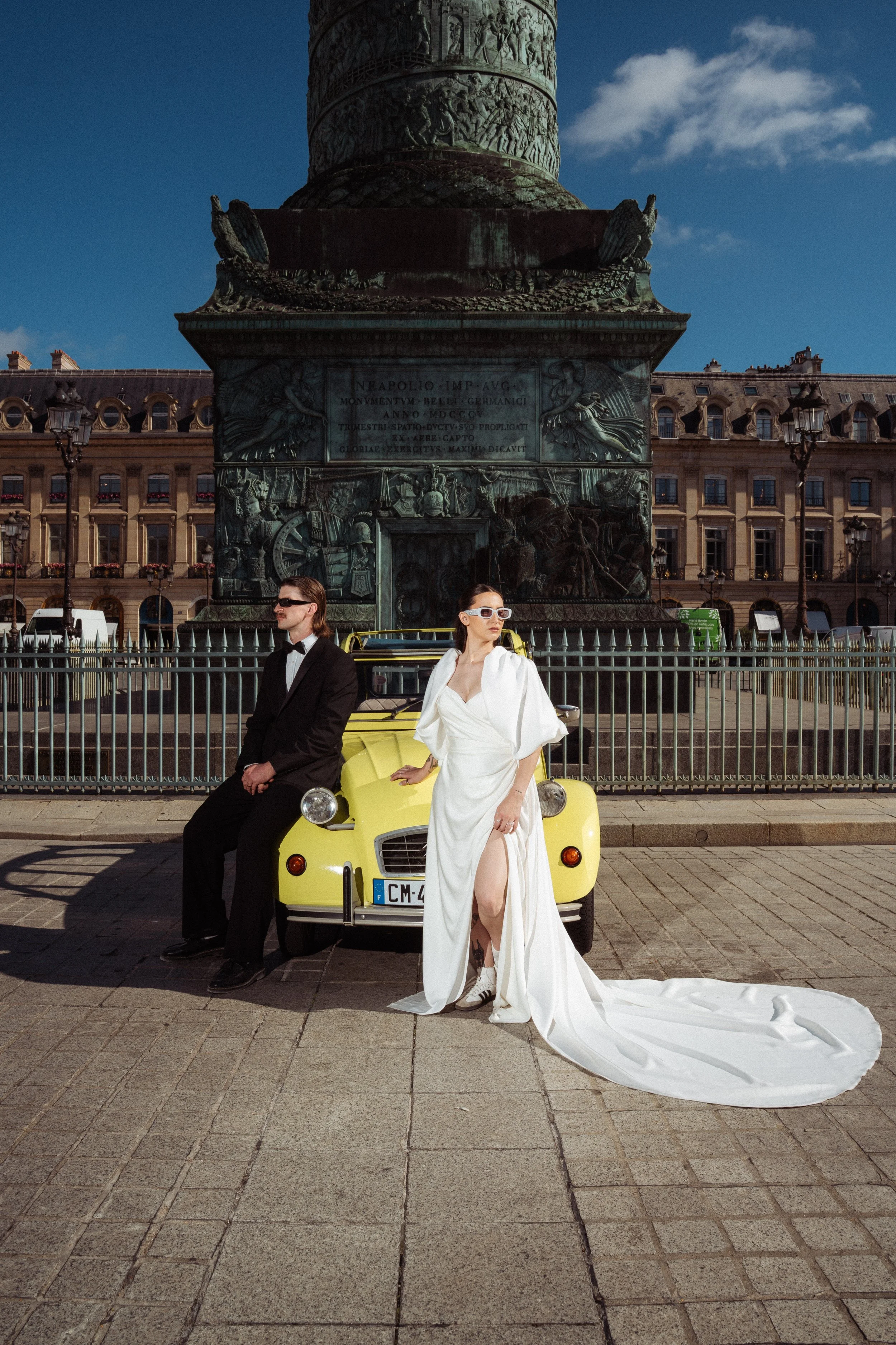 man and woman leaning against a vintage citreon car in concorde square, paris